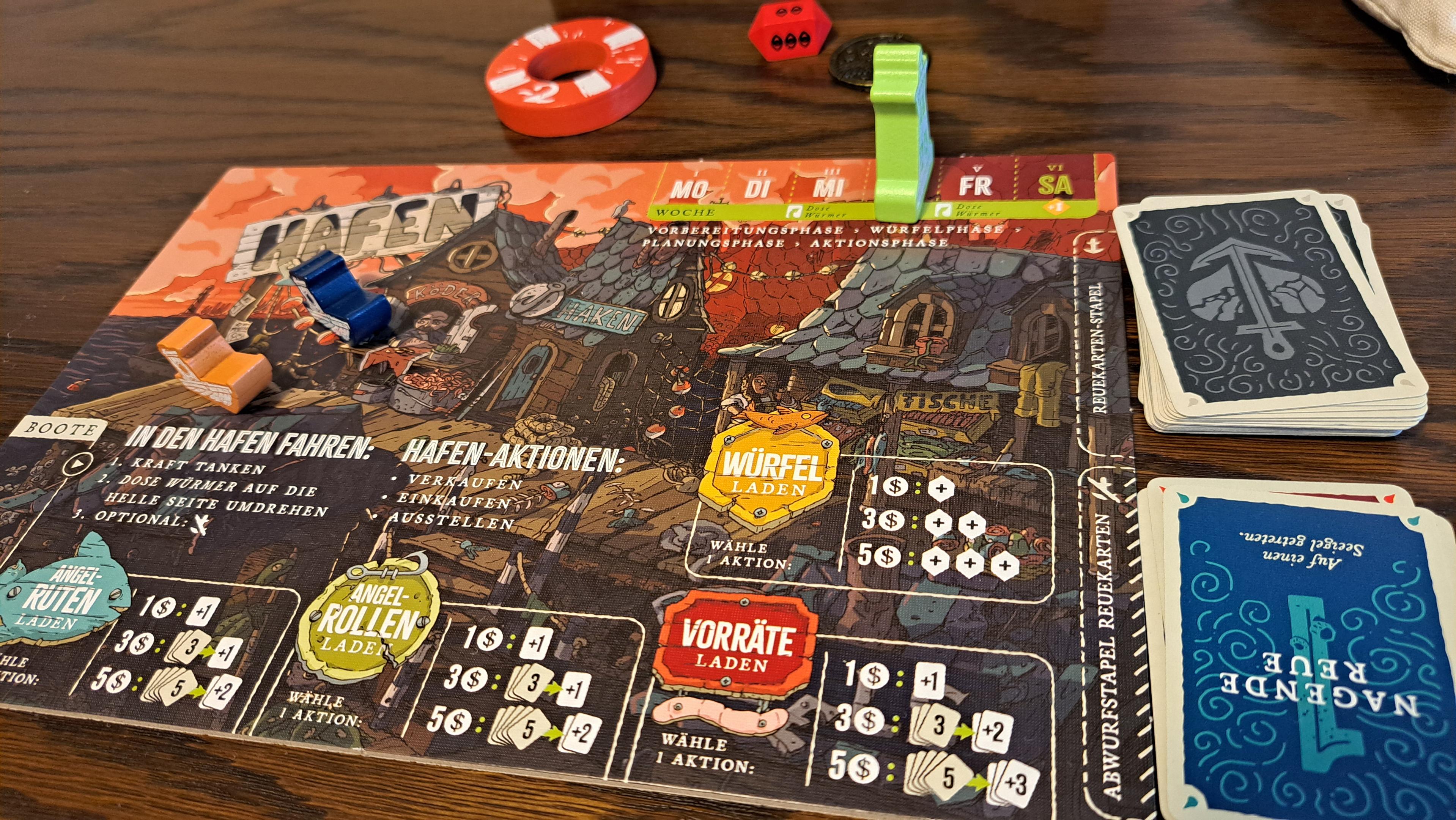 The harbour board, where you can go shopping for gear and dice. There are piles of regret cards to the right of it. Above the board is the safety buoy marker and an ominous red die.