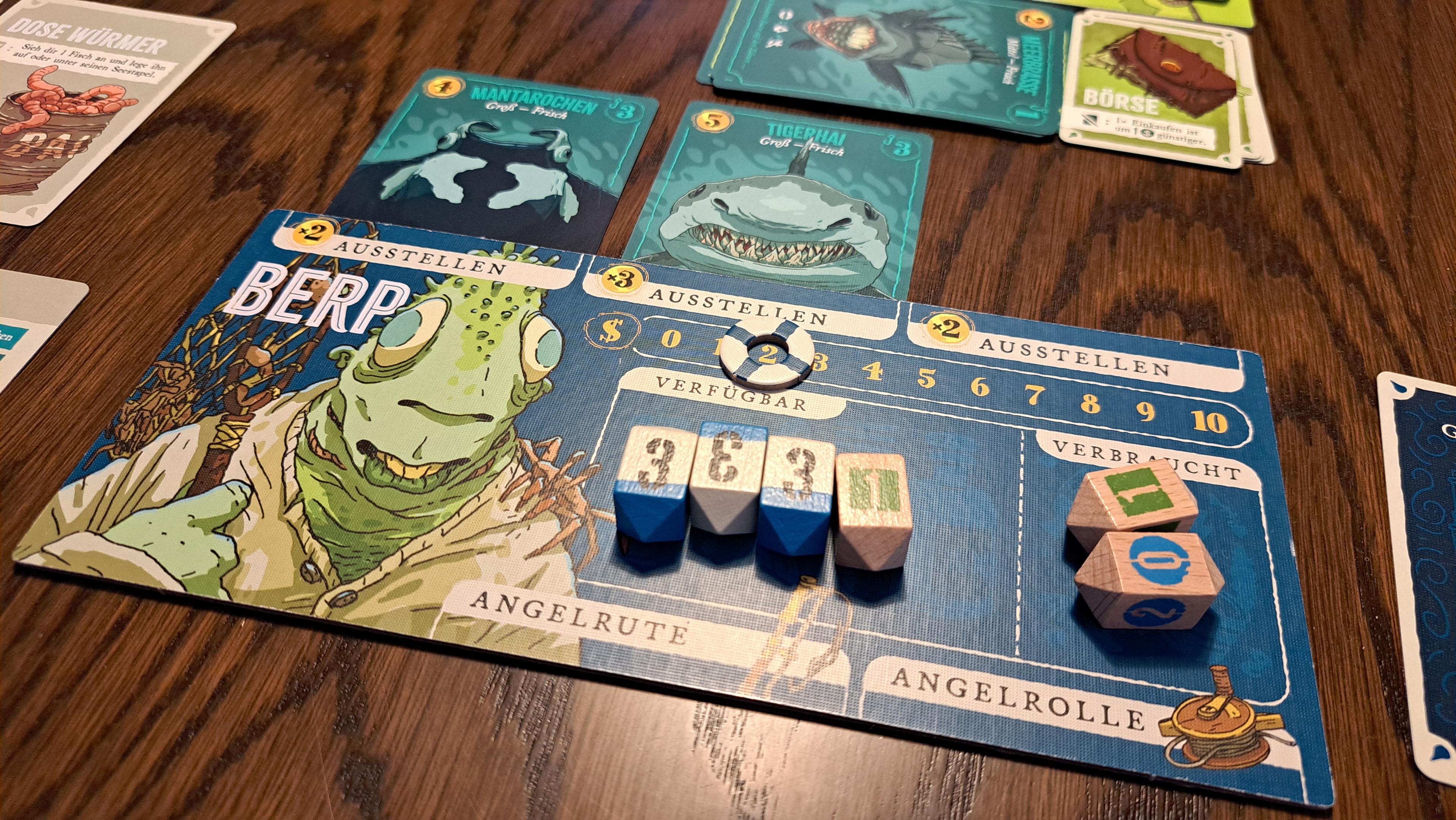 My player board, showing a character named Berp (looking green and froggy, but humanoid - the artwork of the game is pretty awesome, like it was taken out of a graphic novel). On the board, there are weirdly shaped wooden dice.