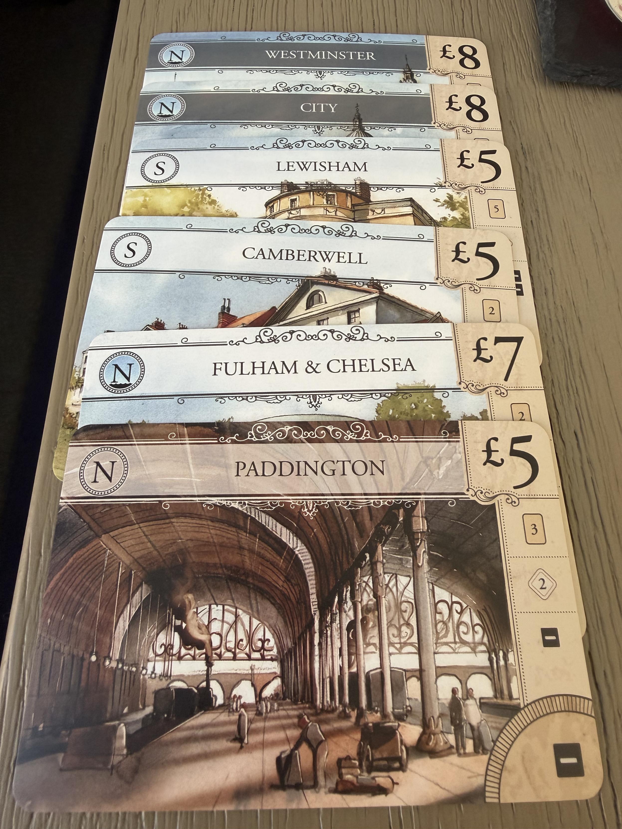 London (2nd Edition) city cards. All in a pile. Paddington at the bottom. Westminster at the top.