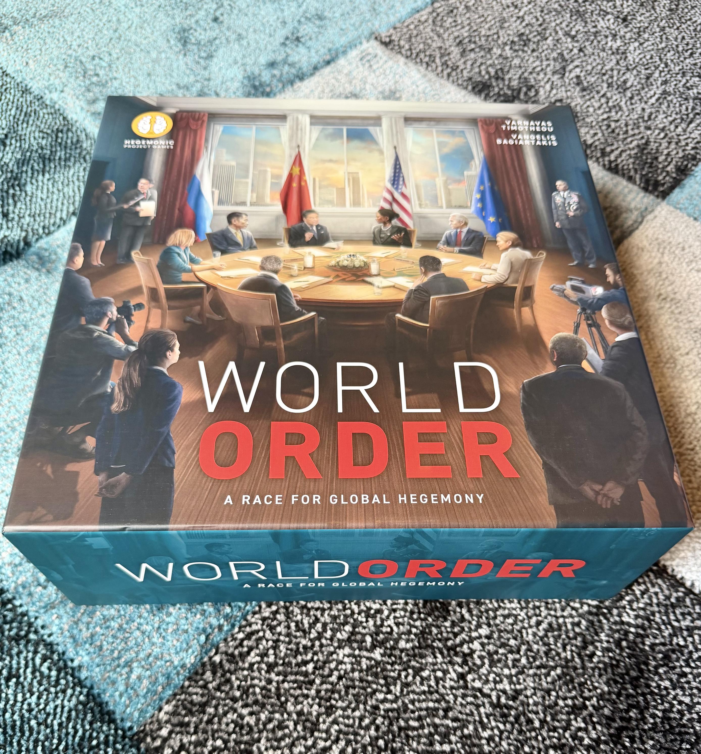 A game box titled "World Order: A Race for Global Hegemony," showing an illustration of world leaders meeting around a large table with flags behind them.
